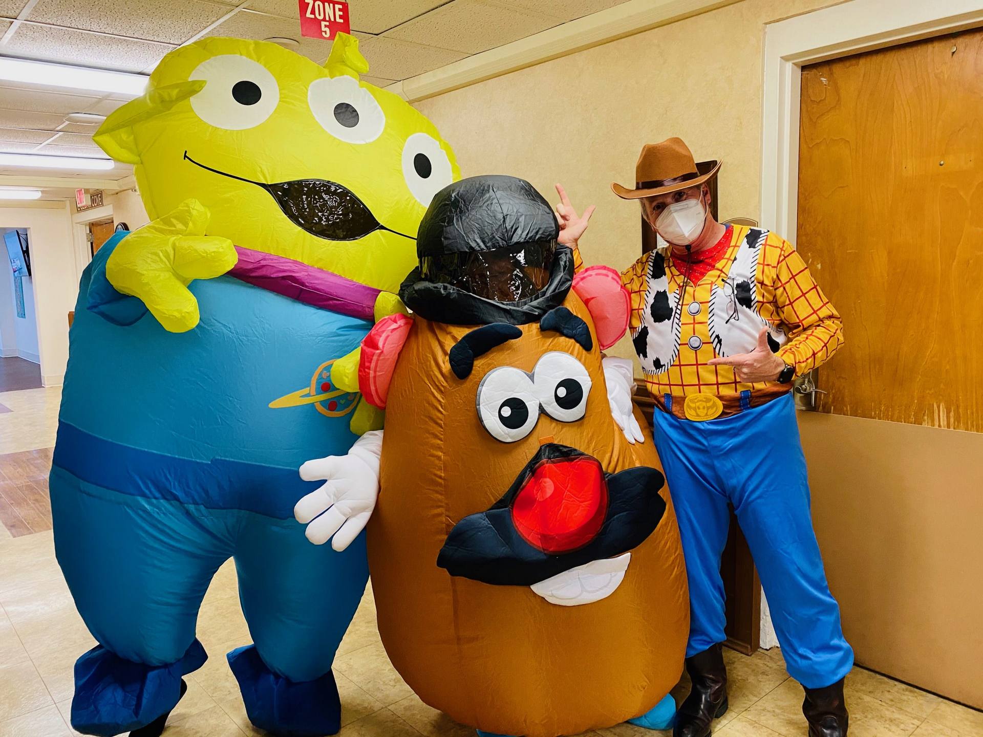 Members of the life enrichment team dressed up like characters from Toy Story.